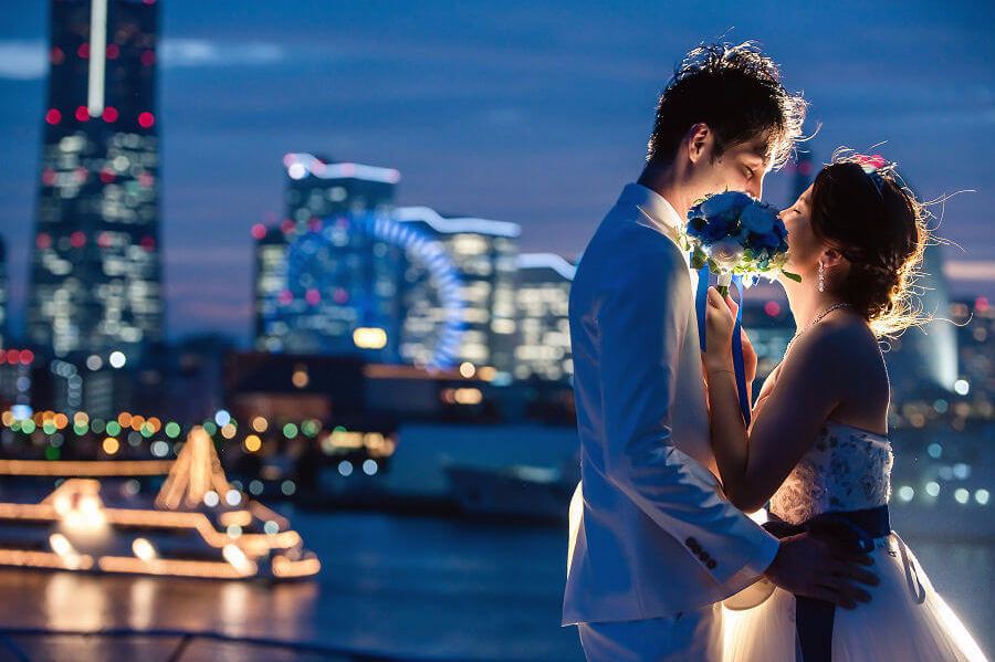 ブーケで顔を隠してキスするふたり