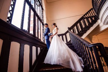 西洋館の階段でポーズするふたり