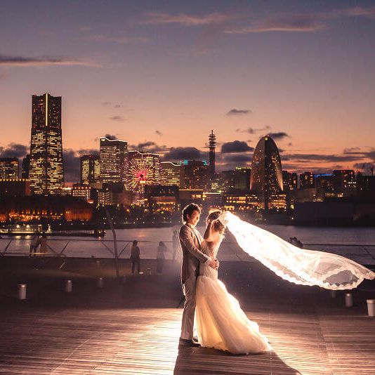 みなとみらいの景色を背景に大桟橋で前撮りするふたり