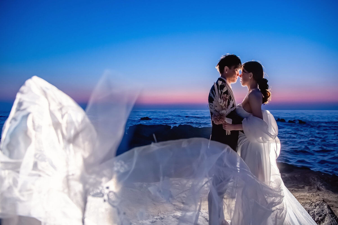 城ヶ島夕焼けをバックに向かい合う新郎新婦